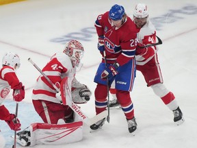 Detroit Red Wings goaltender James Reimer (47) makes a save against Montreal Canadiens' Christian Dvorak (28) as Red Wings' Shayne Gostisbehere (41) defends during first period NHL hockey action in Montreal on Tuesday, April 16, 2024.