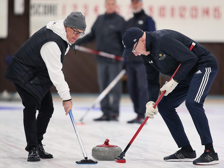  Curlers Marc Gill, left, and Tim Tiegs are shown at the Roseland Curling Club on Friday.