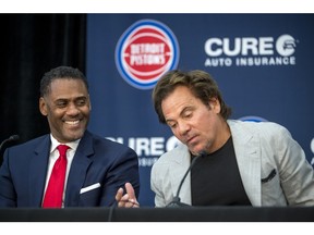 From left, Detroit Pistons' general manager Troy Weaver laughs while listening to owner Tom Gores during a press conference.