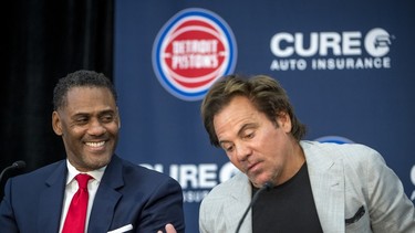 From left, Detroit Pistons' general manager Troy Weaver laughs while listening to owner Tom Gores during a press conference.
