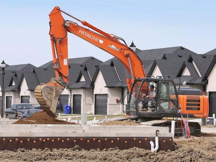  Heavy machinery moves dirt at the foundation of a townhouse under construction on Barkley Avenue in Windsor on Wednesday, April 10, 2024.