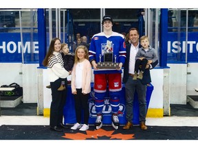 Oakville Rangers' forward Ethan Beltchetz holds the Tim Adams Memorial Trophy as MVP of the OHL Cup.