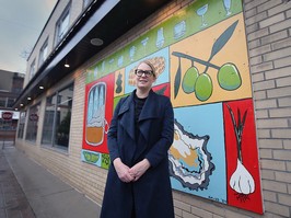 Sarah Dewar beside mural