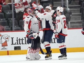 Washington Capitals left wing Alex Ovechkin (8) celebrates with goaltender Charlie Lindgren (79) as Connor McMichael (24) looks on after an NHL hockey game Tuesday, April 9, 2024, in Detroit. The Capitals beat the Red Wings 2-1.