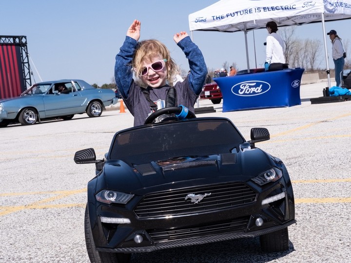 Throw your hands up in the air! Budding sports car enthusiast Grace Hindi, 2, arrives in style at the Mustang 60th anniversary event in Windsor on Sunday.