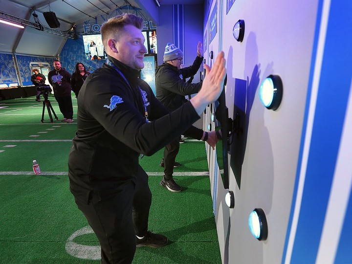  Brenden Szpont beats the crowds as he tries out an interactive game at the Detroit Lions fan experience station in downtown Detroit on Wednesday, April 24, 2024.