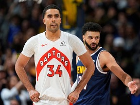 Toronto Raptors center Jontay Porter (34) and Denver Nuggets guard Jamal Murray (27) in the second half of an NBA basketball game Monday, March 11, 2024, in Denver.