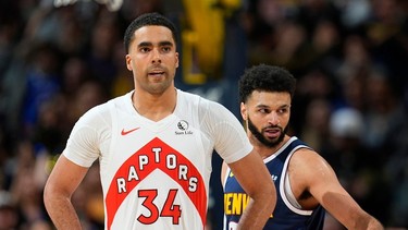 Toronto Raptors center Jontay Porter (34) and Denver Nuggets guard Jamal Murray (27) in the second half of an NBA basketball game Monday, March 11, 2024, in Denver.