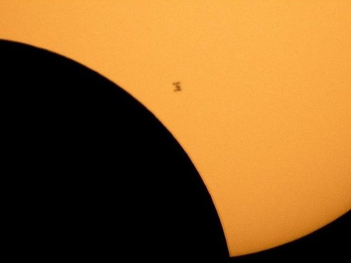  In this file image made available by NASA, the International Space Station is silhouetted against the sun during a solar eclipse on Aug. 21, 2017, as seen from Ross Lake, Northern Cascades National Park in Washington state.