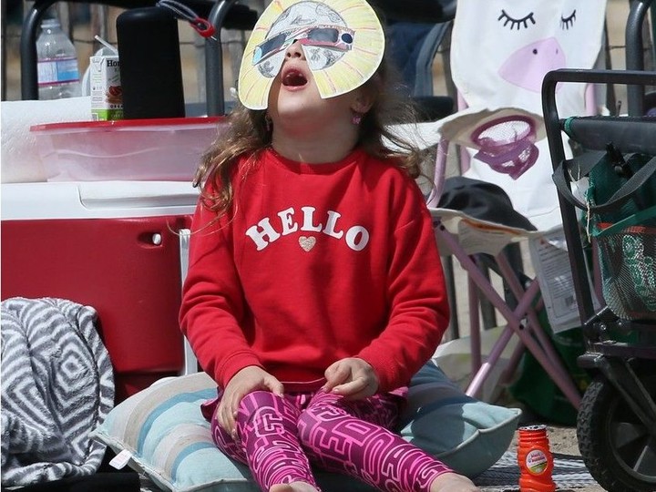  Tenley Miron, 7, of Windsor takes in the solar eclipse on Monday, April 8, 2024 at Seacliff Beach in Leamington.