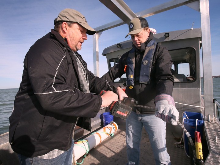  Todd Leadley, left, a field technician with RAEON, and Aaron Fisk, a University of Windsor research chair, prepare to drop a high-tech monitoring buoy in Lake Erie near Leamington on Tuesday, April 16, 2024. DAN JANISSE/Windsor Star