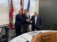 Elgin-Middlesex-London MPP Rob Flack, left, Central Elgin Mayor Andrew Sloan and St. Thomas Mayor Joe Preston shake hands after announcing an agreement between the two municipalities for land taken from Central Elgin for the new Volkswagen plant on Friday, April 19, 2024. (Brian Williams/The London Free Press)