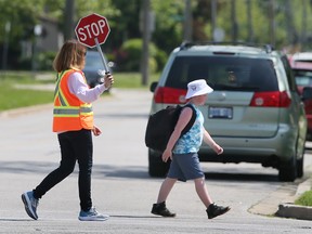 Crossing guard helping child