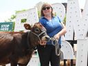 Moo'Durboving Urban Experience: Vicky Morrison, a dairy farmer at Bally Bright Farms, Essex, poses with the Cows at Windsor Farmers Market on Saturday, May 25, 2024.