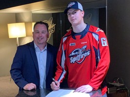 Windsor Spitfires' general manager Bill Bowler, left, looks on as first-round pick Ethan Belchetz officially signs on with the club on Saturday at the WFCU Centre.