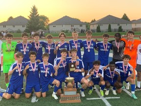 The St. Anne Saints pose with the championship trophy on Thursday after the team's 2-0 win over the Holy Names Knights in the WECSSAA senior boys' AAA soccer championship at the Holy Names high school field.