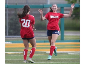 The Holy Names Knights' Alessia Fanella (20),at left and Anna Pozzi (17) celebrate the opening goal of Wednesday's WECSSAA senior girls' AAA soccer championship against the Villanova Wildcats at Acumen Stadium.