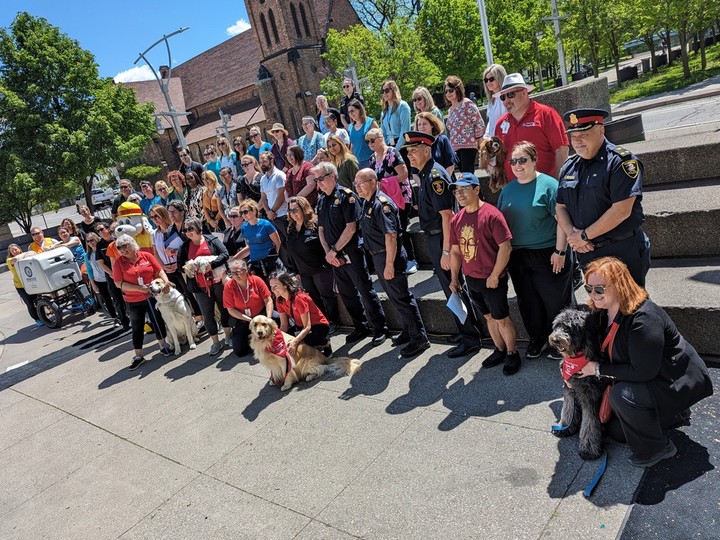  Downtown Windsor workers pose for a photo in Charles Clark Square before taking a Wellness Wednedsay walk to the riverfront on Wednesday, May 8, 2024.