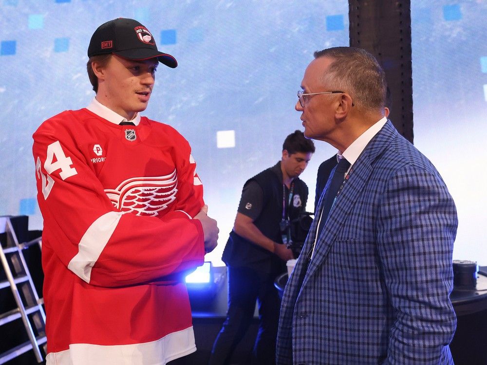 Goalie and Detroit Red Wings' fourth-round pick Landon Miller talks with general manager Steve Yzerman after being selected.