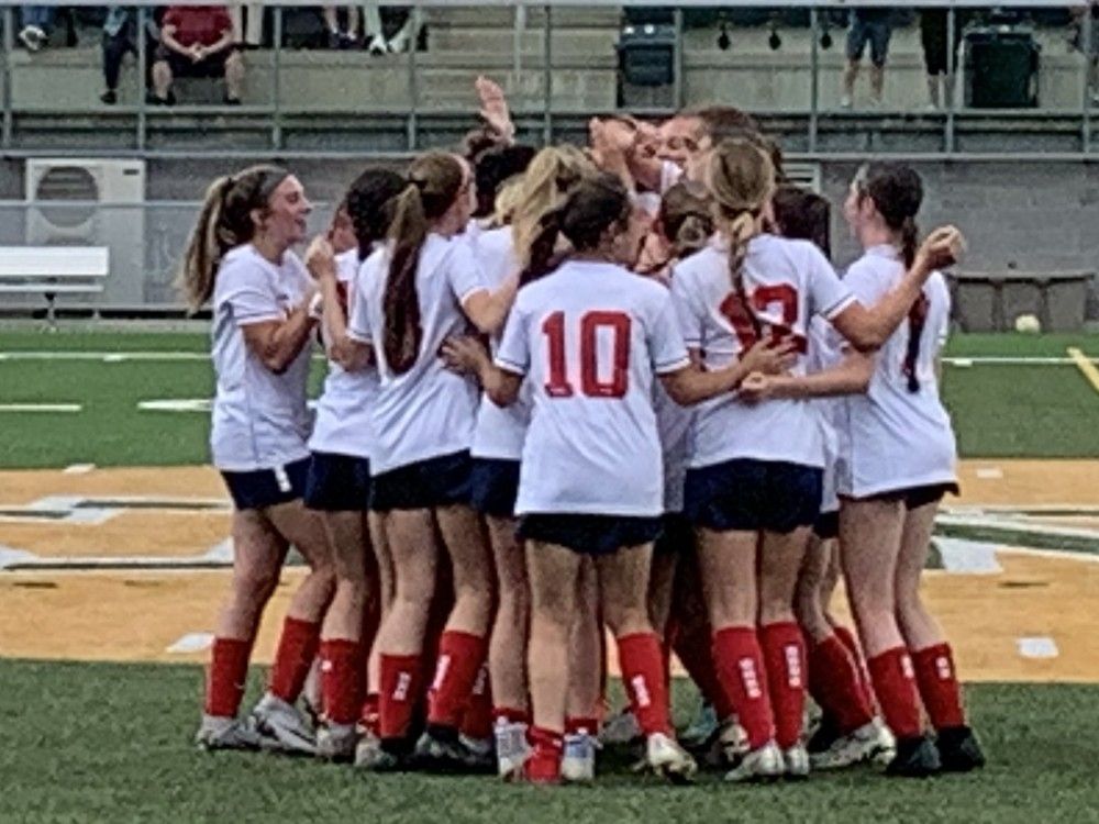 Members of the Holy Names Knights gather to celebrate the team's 2-0 win over St. Thomas Aquinas on Saturday to capture the gold medal at the OFSAA girls' AAA soccer championship, which was played Saturday at Acumen Stadium.