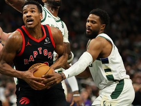 Guard Malik Beasley (#5), at right, seen in action for the Milwaukee Bucks against the Toronto Raptors, will reportedly join the Detroit Pistons on a one-year deal.