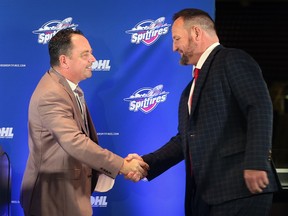 Windsor Spitfires general manager Bill Bowler, left, greets new head coach Greg Walters at a press conference on Tuesday at the WFCU Centre.