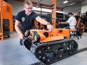 'It’s a robot-in-the-box.' Scott Fairley, founder of Optimotive in Windsor is shown with one of the company's robots on Monday, Sept. 9, 2024.