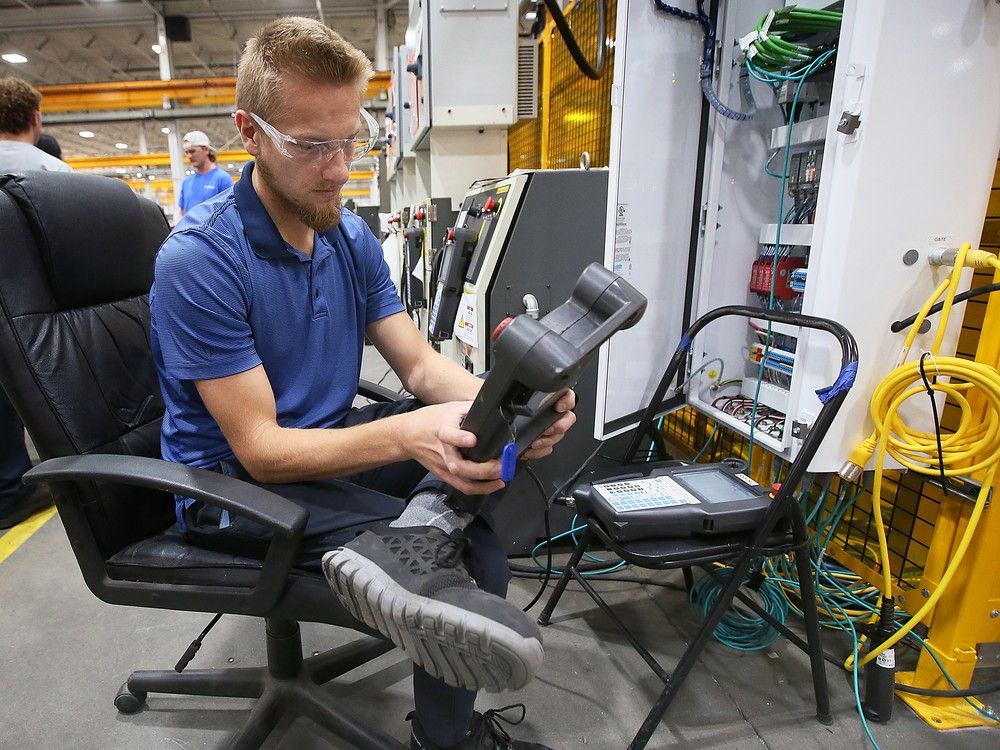 Henry Andkilde, a technician at CenterLine in LaSalle, programs a robotic unit on Friday, Oct. 4, 2024, on Manufacturing Day.