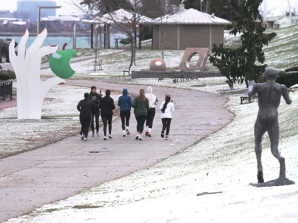  a group of runners are shown on a cold and snowy friday, nov. 29, 2024, along the detroit river waterfront in windsor.
