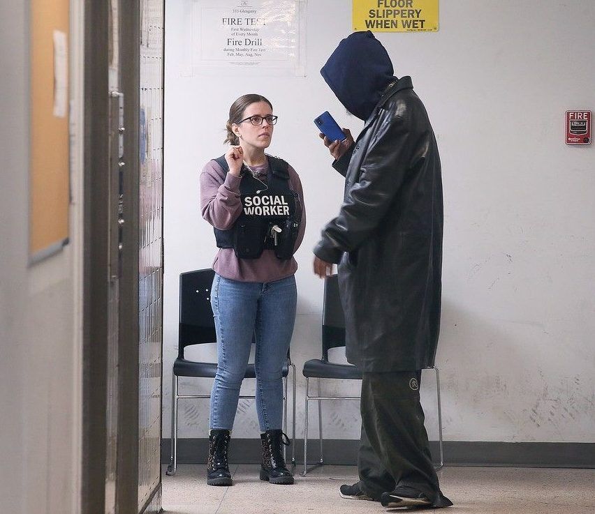 a social worker speaks to a resident at the 333 glengarry apartment building in windsor on nov. 14, 2024.