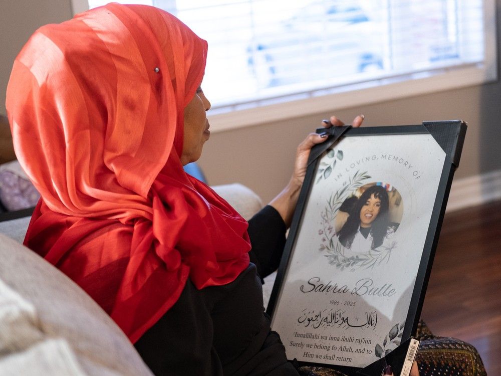  fartumo kusow, mother of sahra bulle, holds a framed image of her daughter on nov. 28, 2023. kusow hosted a #iamsahrabulle conference at the university of windsor on dec. 1, aimed at effecting change for victims of intimate partner violence.