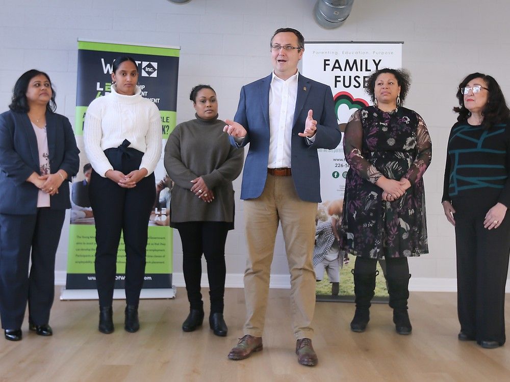 MP Irek Kusmierczyk, centre, speaks during a press conference on Thursday, December 12, 2024 at the Sandwich Teen Action Group in Windsor.