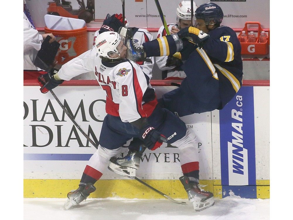 Windsor Spitfires' forward A.J. Spellacy, left, and the Erie Otters' Malcolm Spence collide during Thursday's game at the WFCU Centre.