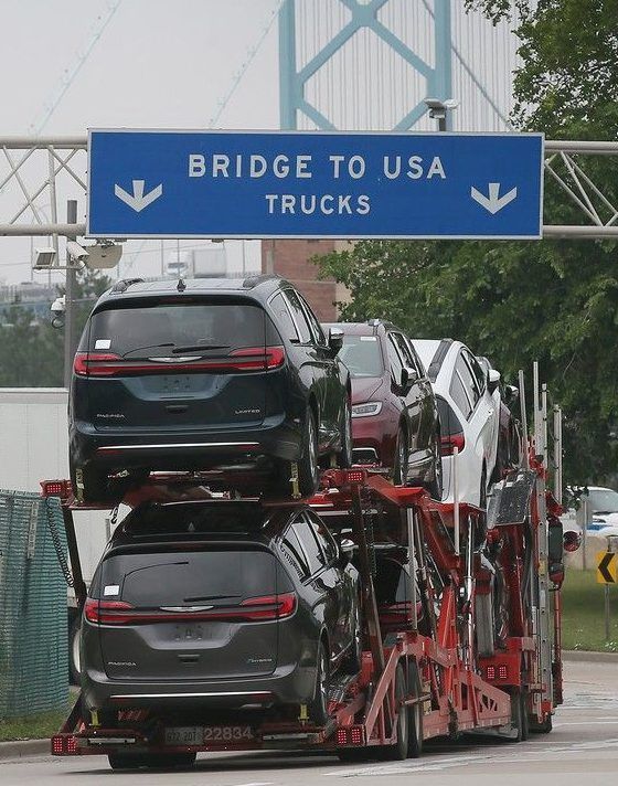  a truck carrying newly built windsor chrysler pacificas heads to the ambassador bridge in windsor, and then the american marketplace, on june 27, 2023.