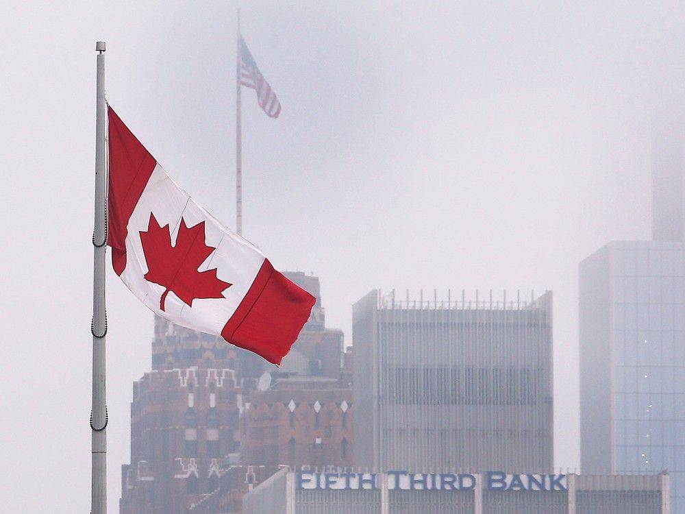  troubled times for longtime good neighbours: a canadian flag flutters in downtown windsor with the detroit skyline in the background on feb. 3, 2025.