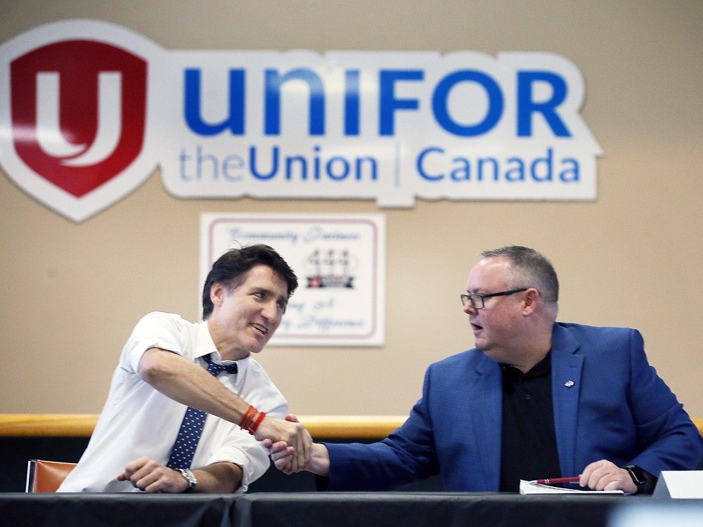  prime minister justin trudeau, left, and unifor local 444 president james stewart shake hands during a meeting at the turner road union hall in windsor on jan. 16, 2025.