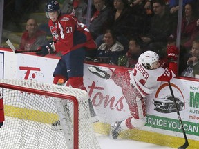 Forard IIYA protas of Windsor Spitfires, left, step away, like sault ste. Marie Greyhounds forward Justin Cloutier hit the worst attempt in Saturday's game.