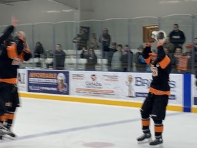 Captain Gabe Piccolo of Essex 73 held up the championship trophy to the right.