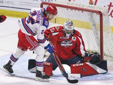 Windsor Spitfires' goalie Joey Costanzo makes a save on Kitchener Rangers' forward Jack Pridham last season as the two teams are now set for the first of four regular-season meetings on Wednesday.
