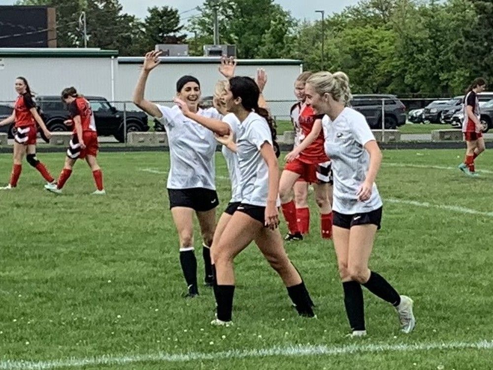  the l’essor aigles’ jasmine dado, centre, celebrates with teammates in the swossaa final.