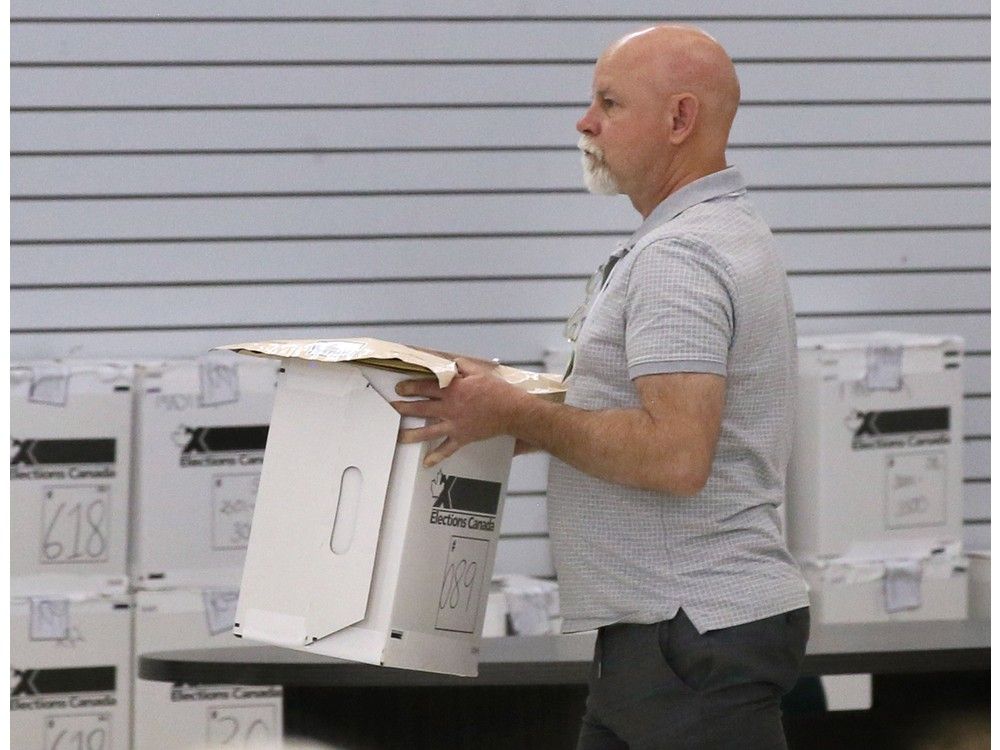 An Elections Canada staff member carries out a box of ballots at the returning office in Tecumseh on Wednesday, May 21, 2025, during a recount for the federal riding of Windsor-Tecumseh-Lakeshore. An Elections Canada staff member carries out a box of ballots at the returning office in Tecumseh on Wednesday, May 21, 2025, during a recount for the federal riding of Windsor-Tecumseh-Lakeshore.