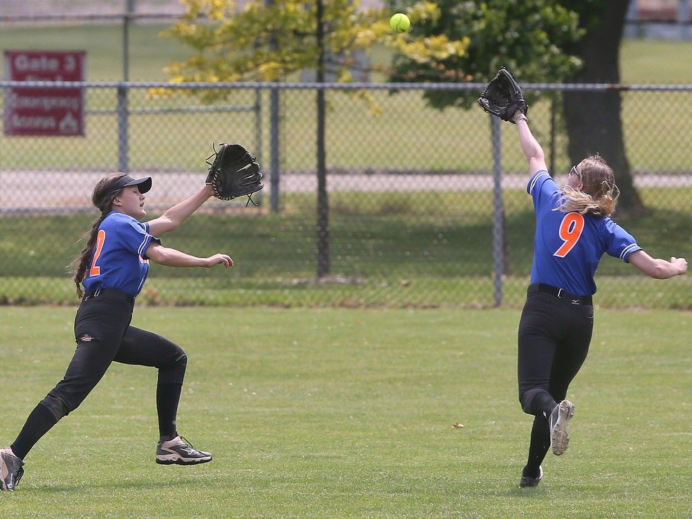  sandwich sabres’ outfielders brook ward, left, and caitlin brayford chase a ball during the ofsaa slo-pitch gold medal game at mic mac park.