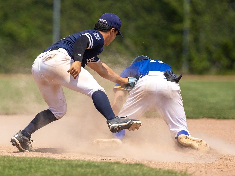  the st. anne saints’ nik larose pops up after easily stealing second base as upper canada college’s christopher nobrega tries for the tag during the ofsaa bronze medal game at stronach park in london.