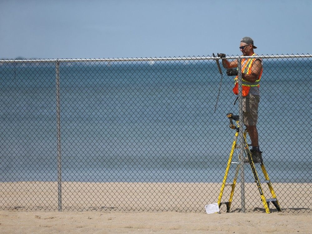 Workers erected a bigger fence across Sand Point Beach, eliminating water access to Windsor's only public beach in the wake of a drowning.