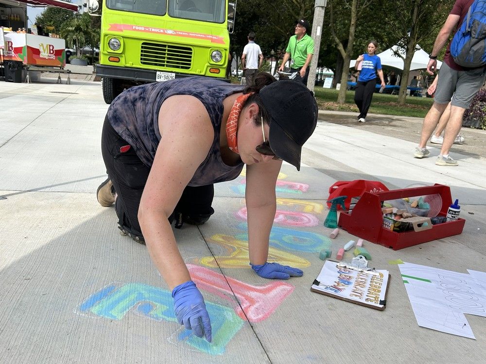  artist chris sisti urges people to celebrate, explore and discover windsor in chalk at the newly unveiled civic square public space prior to the opening ceremonies on sunday, july 13, 2025. (brian macleod/windsor star)