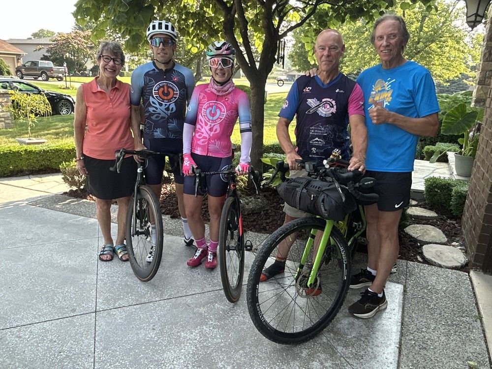  orillia native mark herbst (second from right) poses with his bike at the home of pauline kniaziew (left) and richard kniaziew (right) in leamington tuesday. they are joined by daughter blaire kniaziew-gervais and her husband matt. (brian macleod/windsor star)