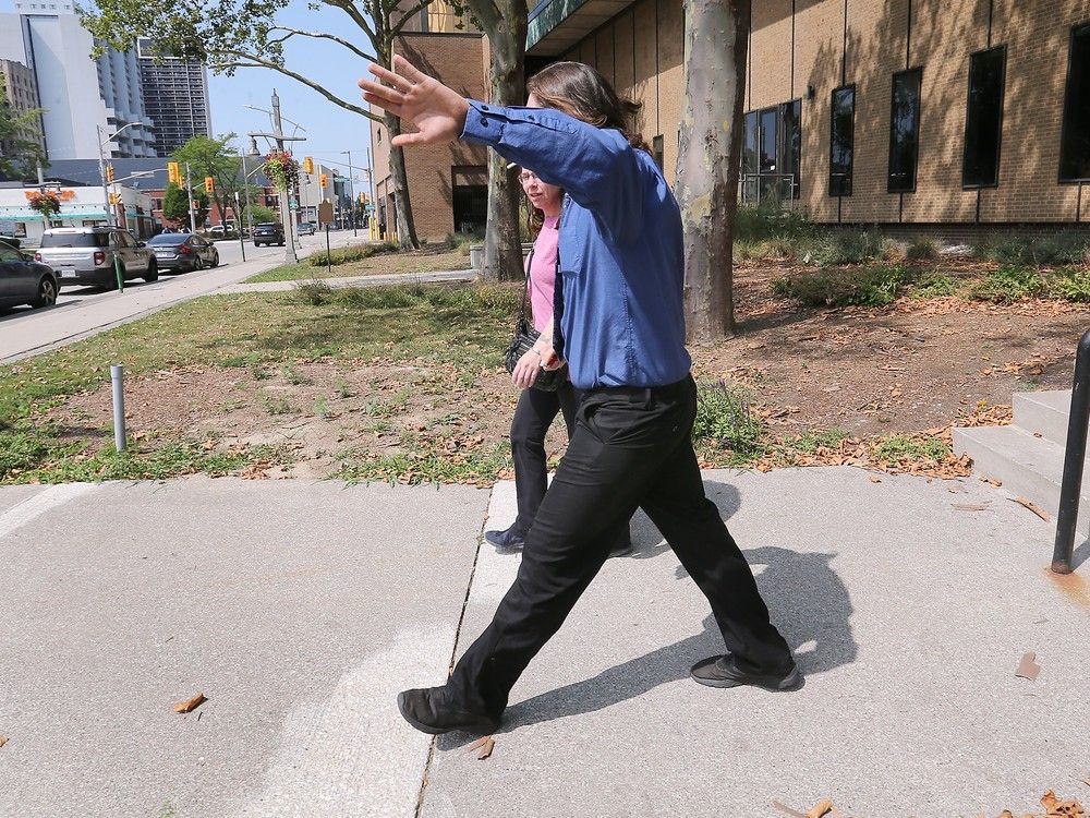  Seth Bertrand shields his face as he exits the Ontario Superior Court of Justice in Windsor on Thursday, Aug. 7, 2025 after being found guilty on terrorism-related charges.