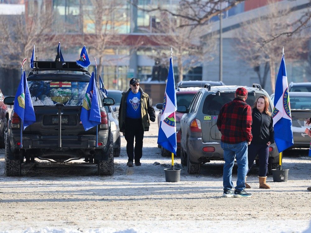Flags and banners the parking lot as people arrived to sign an Alberta separatism petition at the Big Four building in Calgary on Monday, January 26, 2026. Gavin Young/Postmedia