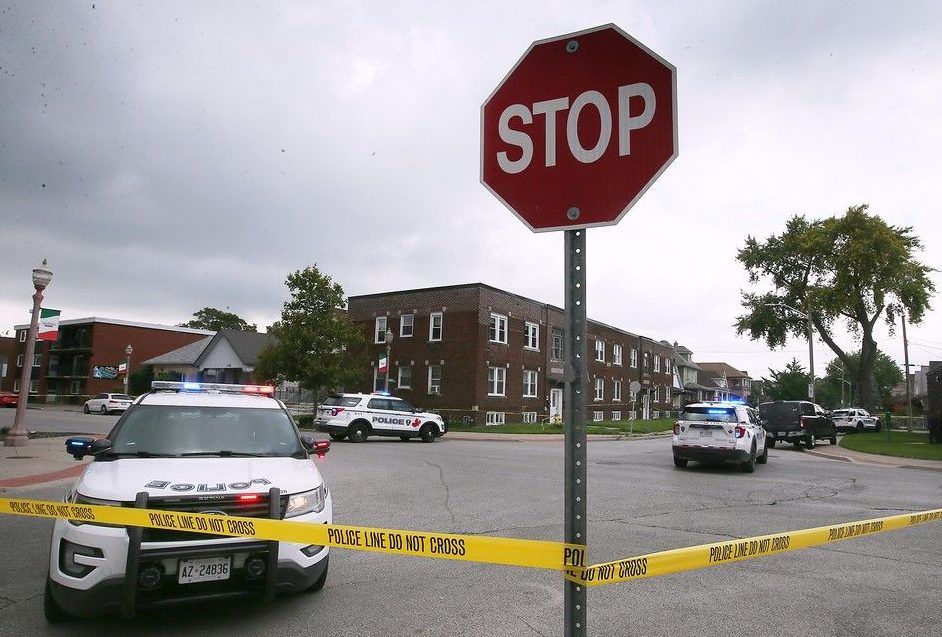  Windsor olice officers cordon off the scene of a shooting in Windsor’s Little Italy neighbourhood on Aug. 15, 2023.