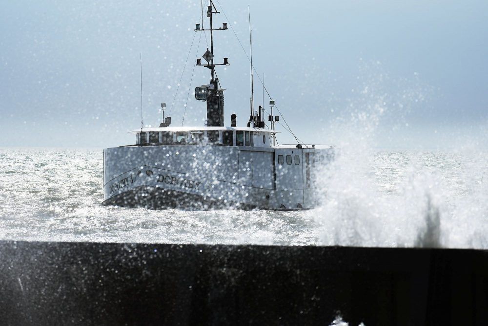 A ship pulls into Wheatley harbour as waves from Lake Erie splash into a break wall. (File Photo/Tom Morrison/Postmedia)